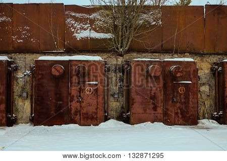 Nuclear bunker. Nuclear bomb shelter. Old abandoned Soviet Cold War bunker in forest. Locked steel gate with ventilation vents.