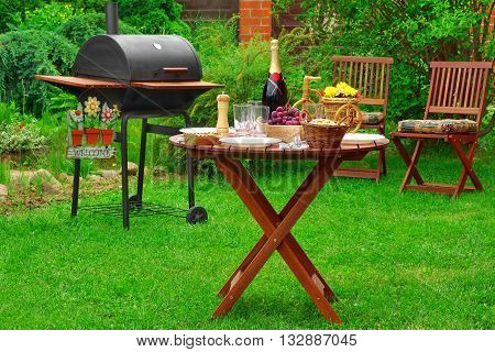Summer Barbecue Family Party Scene With Grill On   Backyard Garden