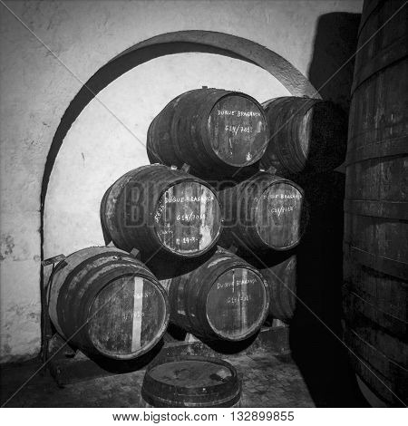 PORTO PORTUGAL - MAY 3 2015: Barrels or pipes of vintage port wine are stured under an arch in the cellar of the Ferriera port lodge to age in Porto Portugal.