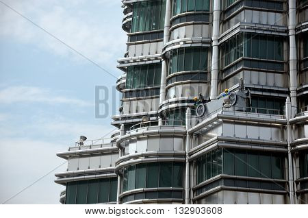Window cleaners are working on the top of the tower