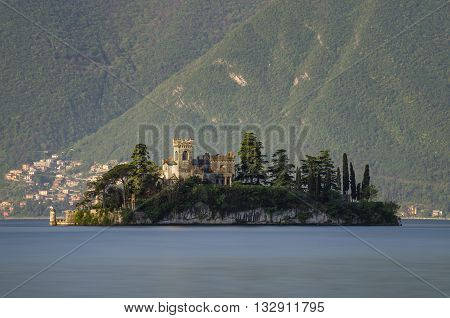 Little island Isola di Loreto on Iseo Lake at sunrise Italy