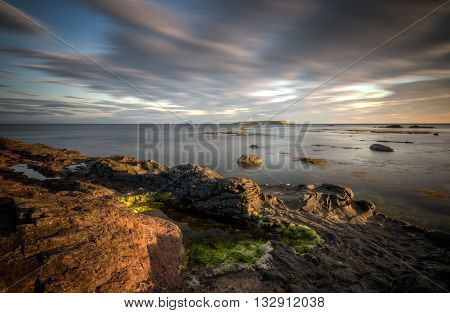 Pladda lighthouse with rocky coastline on sunset Isle of Arran Scotland