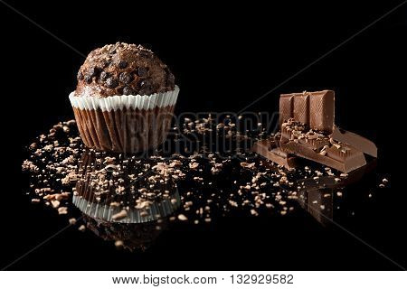 muffin with cocolate on black with reflection