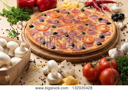 Delicious pizza served on table with vegetable