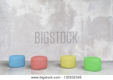 Colorful padded stools in grey concrete room. 3D Rendering