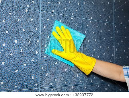 woman washes a tile in the bathroom hand closeup