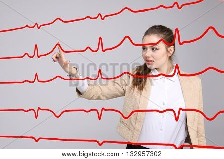 Doctor woman working with cardiogram lines