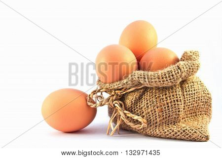 Brown eggs in canvas sack isolated on a white background