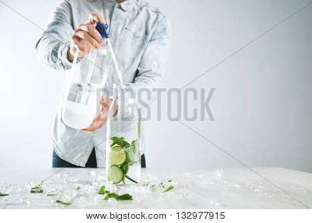 Man Cooks Homemade Lemonade, Pours Sparkling Water From Soda Syphon To Vintage Bottle With Ice Limes