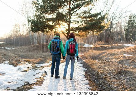 Hiking couple in spring forest. Outdoor adventures concept.