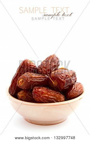 Dry dates in bowl on white background