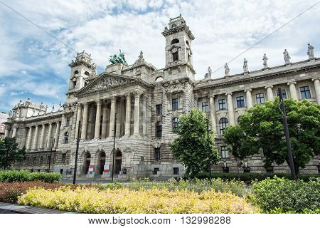 Beautiful Ethnographic museum building and bed of seasonal flowers Budapest Hungary. Cultural heritage. Travel destination. Famous place. Tourism theme. Architectural theme. Kossuth square.