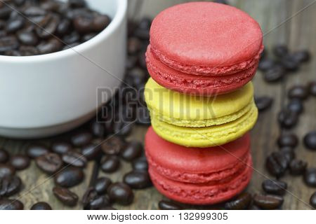 colourful french macaroons and coffee bean on wooden table