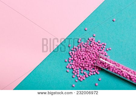 Plastic Pallets . Plastic Raw Materials In Granules For Industry. Polymeric Dye Pink On A Turquoise 