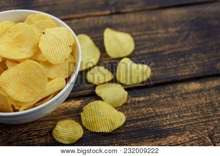 Crispy Potato Chips In A Bowl On An Old Wooden Vintage Table.