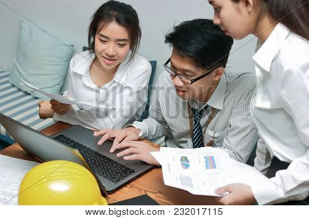 Group Of Young Asian Business People Working Together On A Laptop Computer At Office. Teamwork Brain