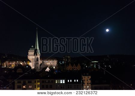 Zurich Switzerland By Night With River, Church And University Building