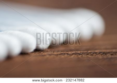 Ear Wand Of White Cotton Buds Or Cotton Swab On Wooden Background.