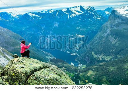 Tourism Vacation And Travel. Female Tourist Taking Photo With Camera, Enjoying Geiranger Fjord And M