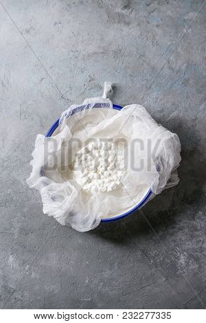 Fresh Homemade Cottage Cheese In Cheesecloth Served In Ceramic Bowl Over Grey Texture Background. To
