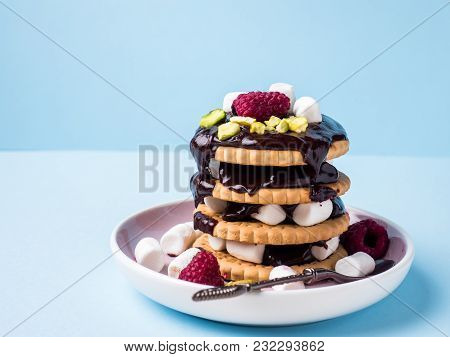 A Sweet Dessert Of A Chocolate Cookie Raspberry And Marshmallow Cup Of Coffee On A Light Blue Table