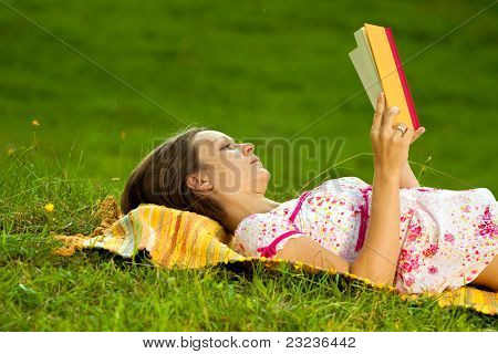 Beatiful Woman Reading In The Park
