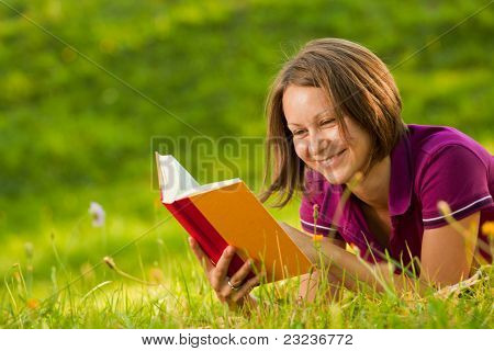Beautiful Woman Laughing With A Book In The Park