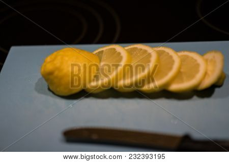Fresh Juicy Lemon. Slice Thin Slices On A Cutting Board With Knife