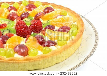 Fresh Homemade Multi Fruit Tart Cake On A Plate And Isolated On A White Background In Closeup.