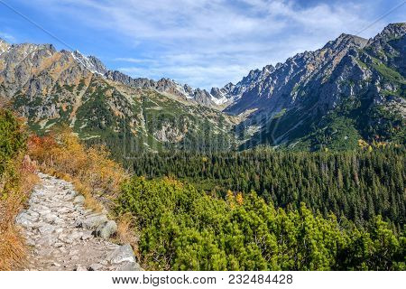 Hiking Trail Among Scenic Landscape Of High Mountains On A Sunny Day