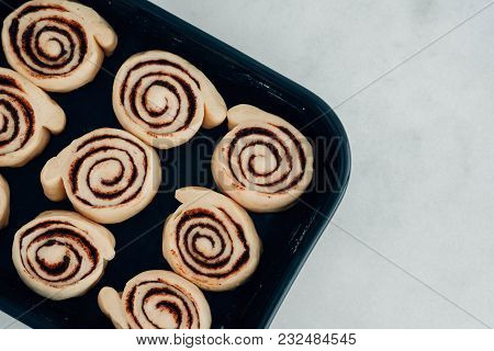 Cinnamon Rolls Or Cinnabon Handmade Raw Dough Preparation With Spices. Sweet Homemade Pastry Christm