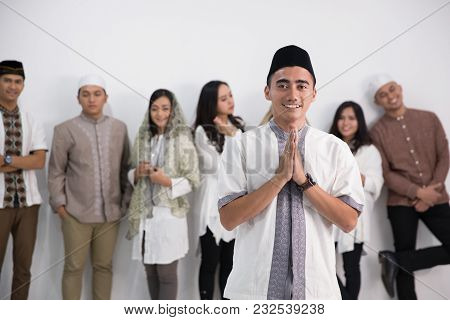 A Muslim Man Standing In Front Of A Group In Studio