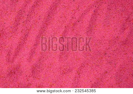 Texture Of A Colored Granular Sand Close Up. Pink Grains