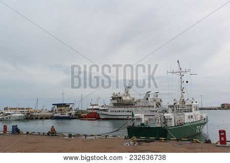 Russia, Krasnodarskiy Kray, Sochi - March 08.2010: Fishermen On The Pier In The Waters Of The Seapor