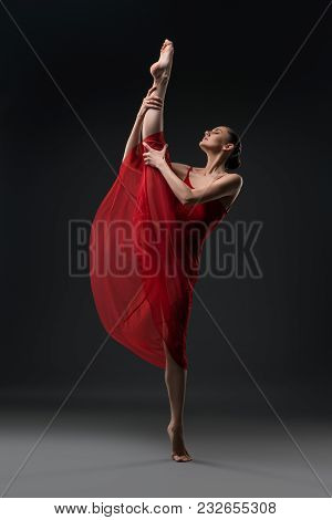Pretty Girl Wearing Red Chiffon Dress Dancing Barefoot In The Dark Room