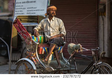 VARANASI, INDIA - MAR 23, 2018: Indian trishaw waiting passengers on the street. According to legends, the city was founded by God Shiva about 5000 years ago.