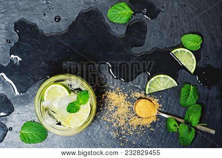 Refreshing Mint Cocktail Mojito With Rum And Lime, Cold Drink Or Beverage With Ice On Black Backgrou