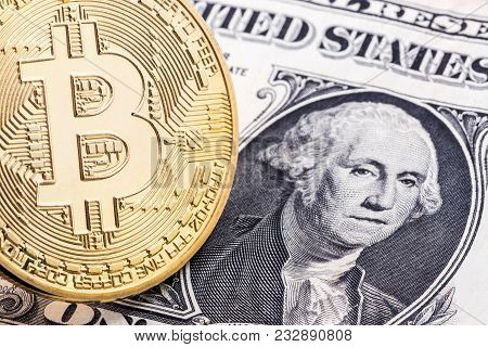 Close-up Of A Golden Bitcoin On 2 Dollar Bill Background