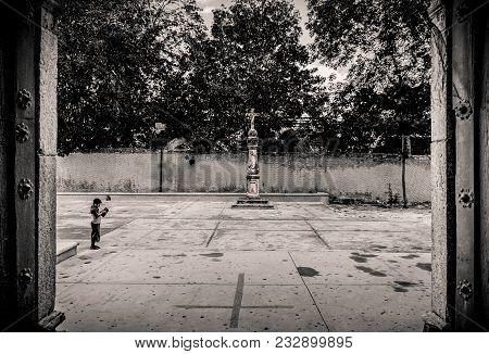 Valladolid, Mexico - 05/17/2017 -  A Child Outside The Cathedral Of San Gervasio