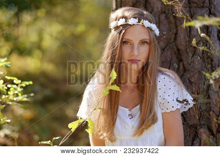 Freckled Woman With Circlet Of Flower On Her Head Portrait In Autumn Forest In A Day Light.