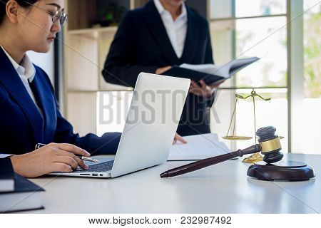 Judge Gavel With Justice Lawyers Having Team Meeting At Law Firm In Background. Concepts Of Law.