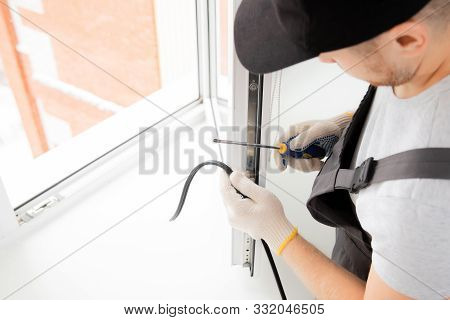 Worker In Installing Rubber Seals On Plastic Upvc Window