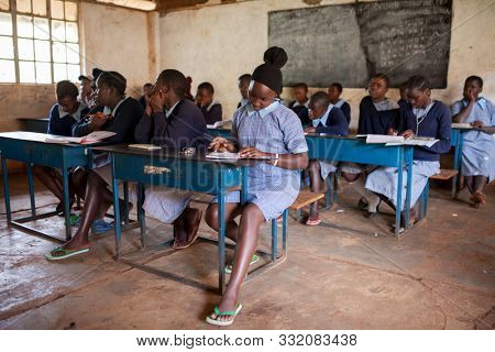 NAIROBI, KENYA-SEPTEMBER 10, 2014: Unidentified girls study in a simple classroom near Nairobi, Kenya.