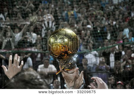 Goldener Ball-Trophy und Fußball-Fans