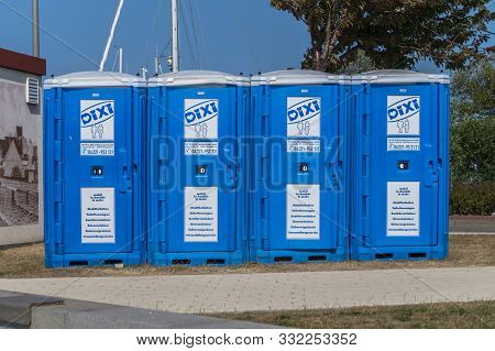 Heiligenhafen, Germany - July 20, 2018: Portable Dixi Toilets In A Row. Near The Harbor Of Heiligenh