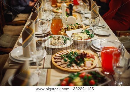 A Meat Plate Next To A Glass Of Red Juice. Table Decor At A Banquet. Celebration In The Restaurant.