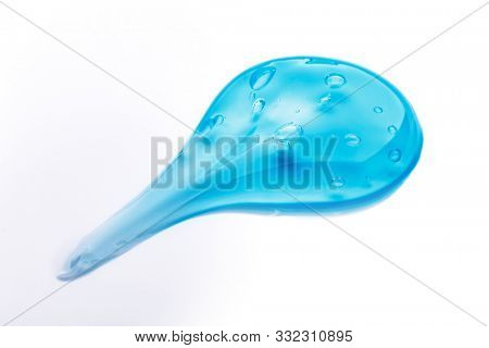 Squeezed cosmetic clear cream gel texture Iisolated on white background. Close up photo of transparent drop of skin care product. High Quality transparent serum with bubbles closeup on white
