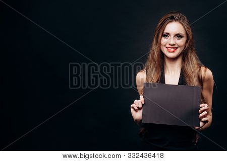 Cute Woman Posing With A Blank Dark Sheet