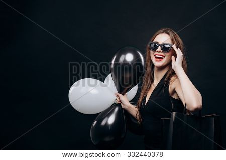 Chic Female Customer With Black And White Balloons