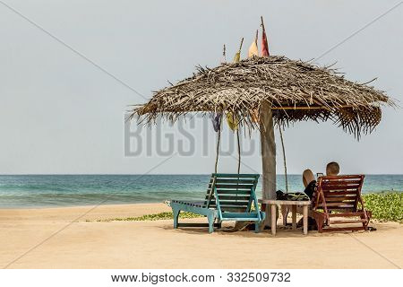 A Guy Is Relaxing At Bentota Beach In Sri Lanka.